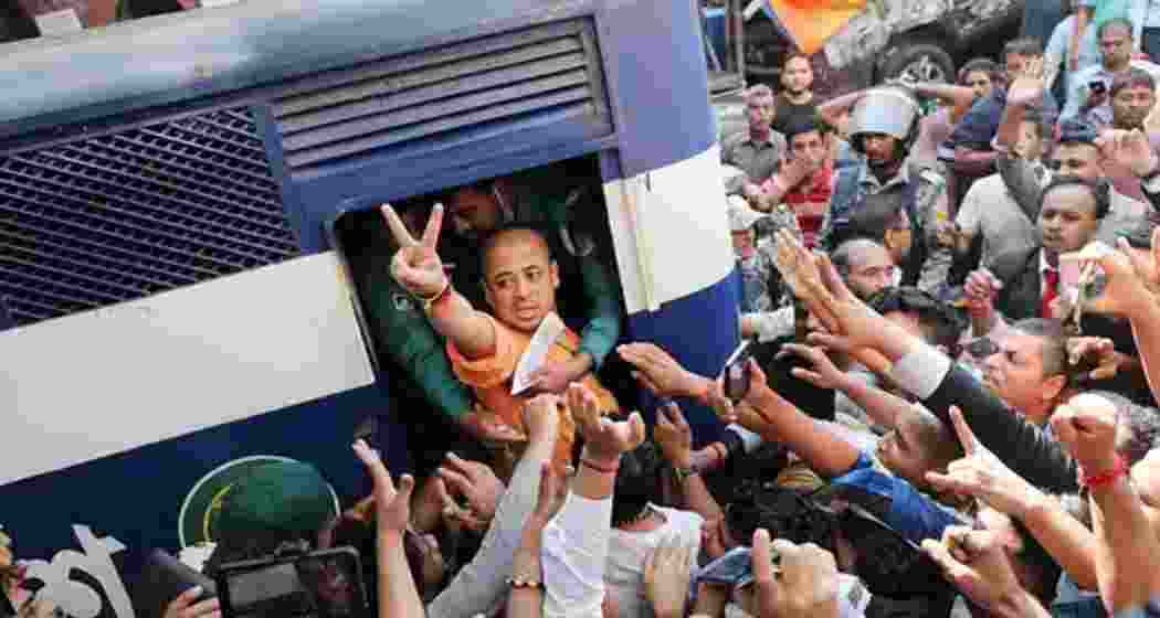 Hindu leader Chinmoy Krishna Das Brahmachary being dragged inside a police van following his arrest in Chattogram, Bangladesh over sedition charges. Hindu leader Chinmoy Krishna Das Brahmachary being dragged inside a police van following his arrest in Chattogram, Bangladesh over sedition charges.