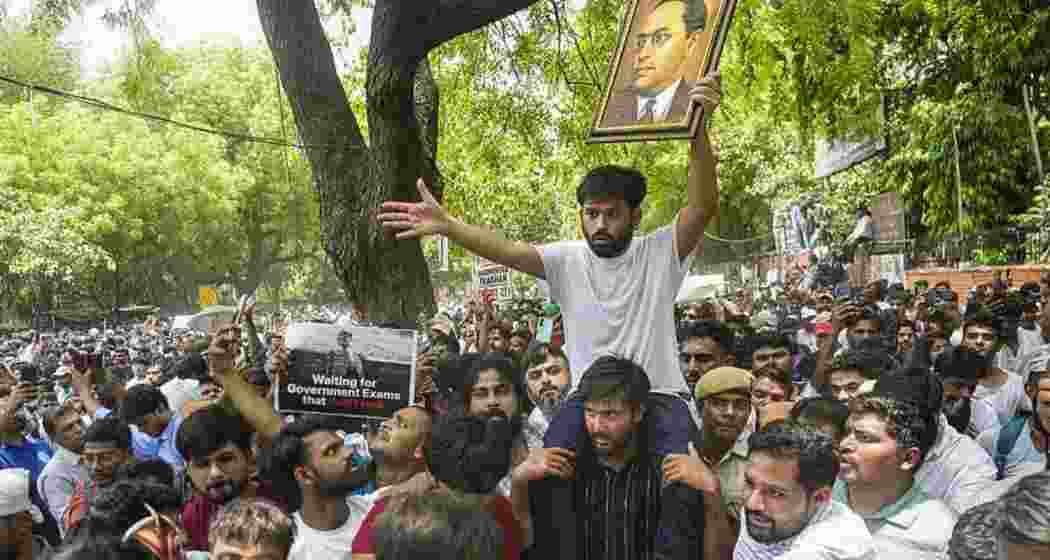 A supporter carries the Cockroach Janta Party (CJP) founder Abhijeet Dipke over his shoulder.