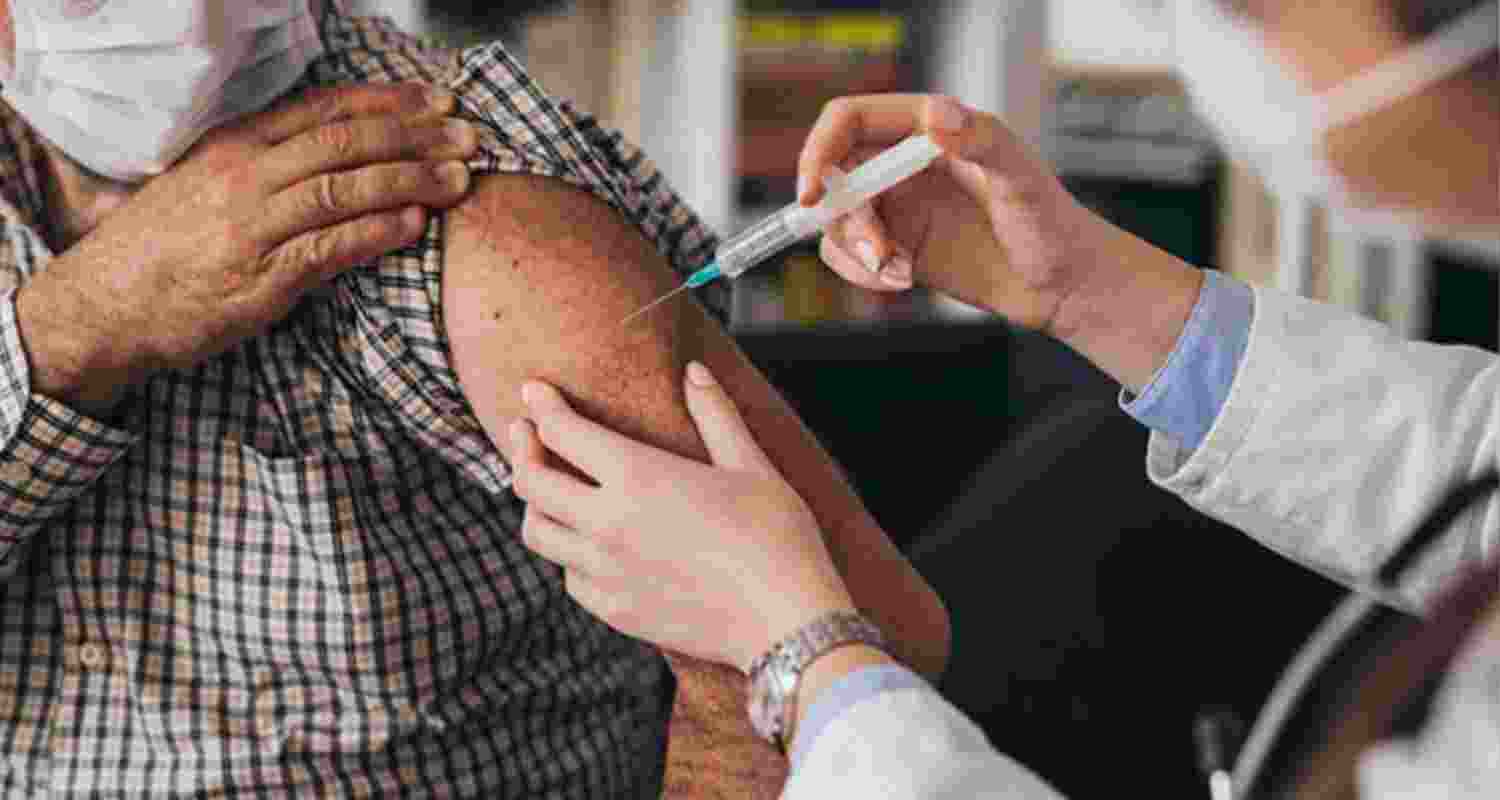 Image of man getting COVID vaccine. 