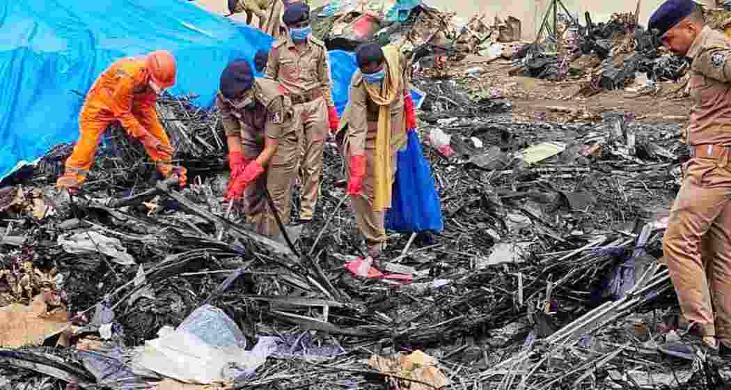 SDRF and Police personnel conduct a search operation at the Air India AI-171 flight crash site, in Ahmedabad. Photograph: @dgpgujarat/X