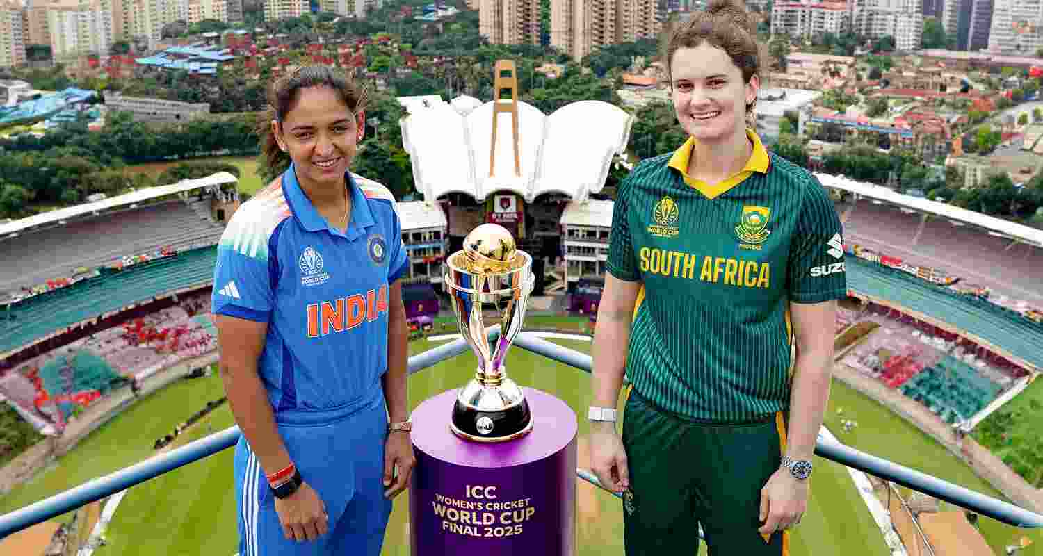 India's captain Harmanpreet Kaur and her South African counterpart Laura Wolvaardt posing with the trophy ahead of the ICC Women's World Cup final cricket match.