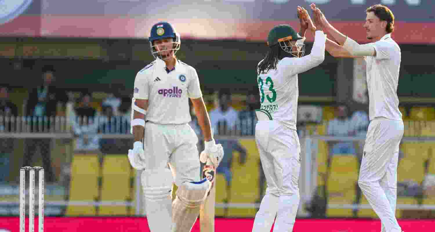 Yashasvi Jaiswal (left) walks off after being dismissed as South African players celebrate on the fourth day of the Test match between India and South Africa at the Barsapara Cricket Stadium in Guwahati on Tuesday.