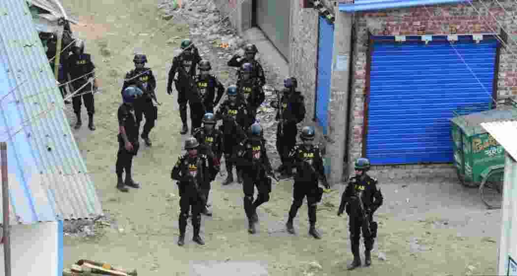 Security forces patrol a street in Bangladesh during Operation Devil Hunt aimed at controlling unrest and detaining perpetrators of recent violent incidents. File photo.