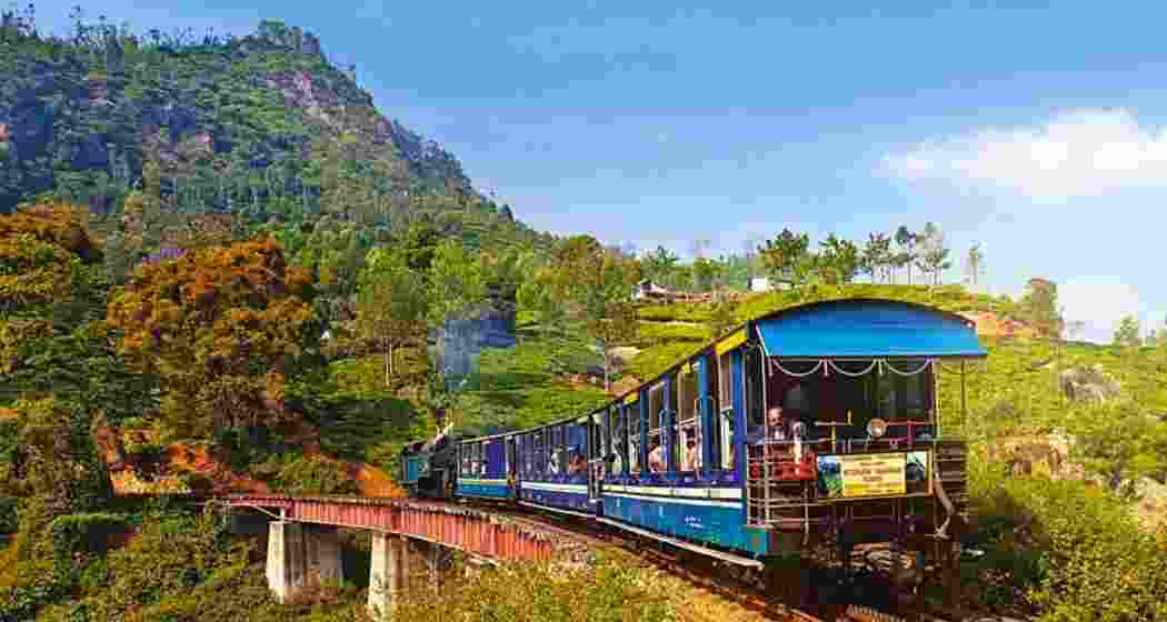 The iconic Darjeeling toy train chugs through the hills.