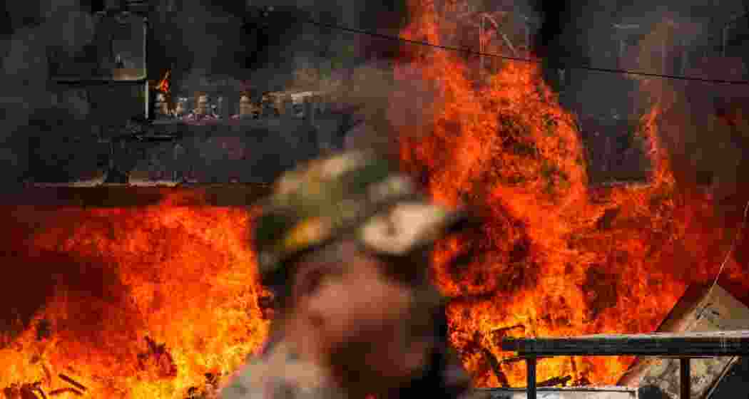 Flames rise after a fire broke out at Brahmaputra Apartments, in New Delhi, Saturday.