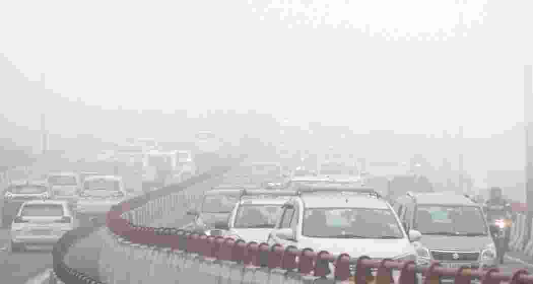 Vehicles move on a road amid morning fog, in New Delhi on Friday, Jan. 3, 2025.