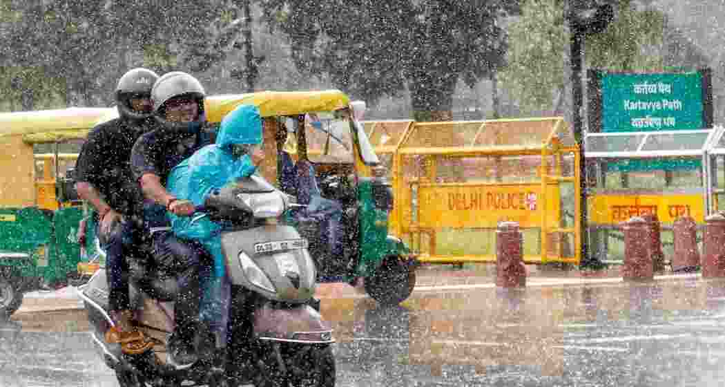 Commuters wade their way amid heavy rain.