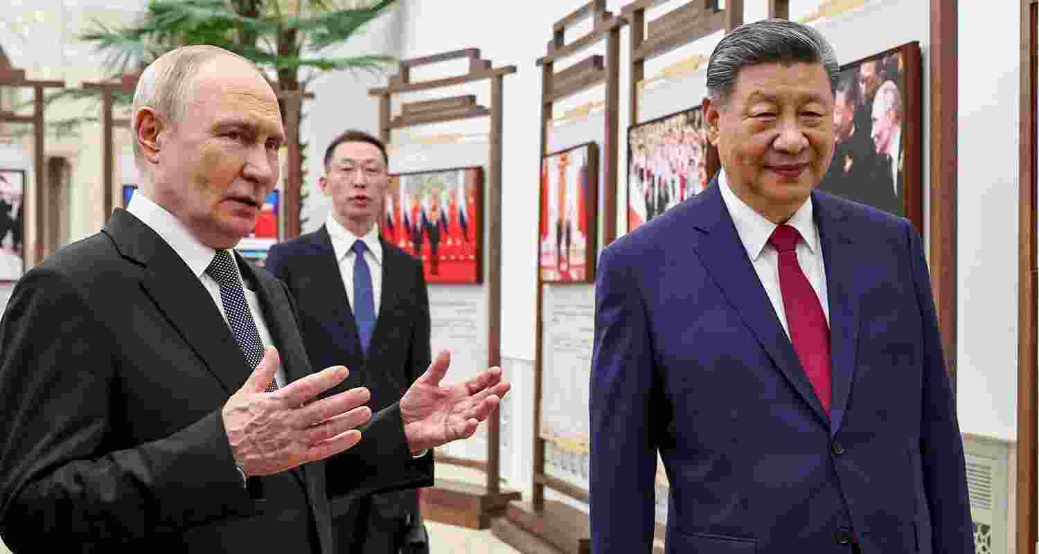Russian President Vladimir Putin and Chinese President Xi Jinping visit an exhibition by the TASS and Xinhua news agencies at the Great Hall of the People in Beijing, China, on Wednesday.