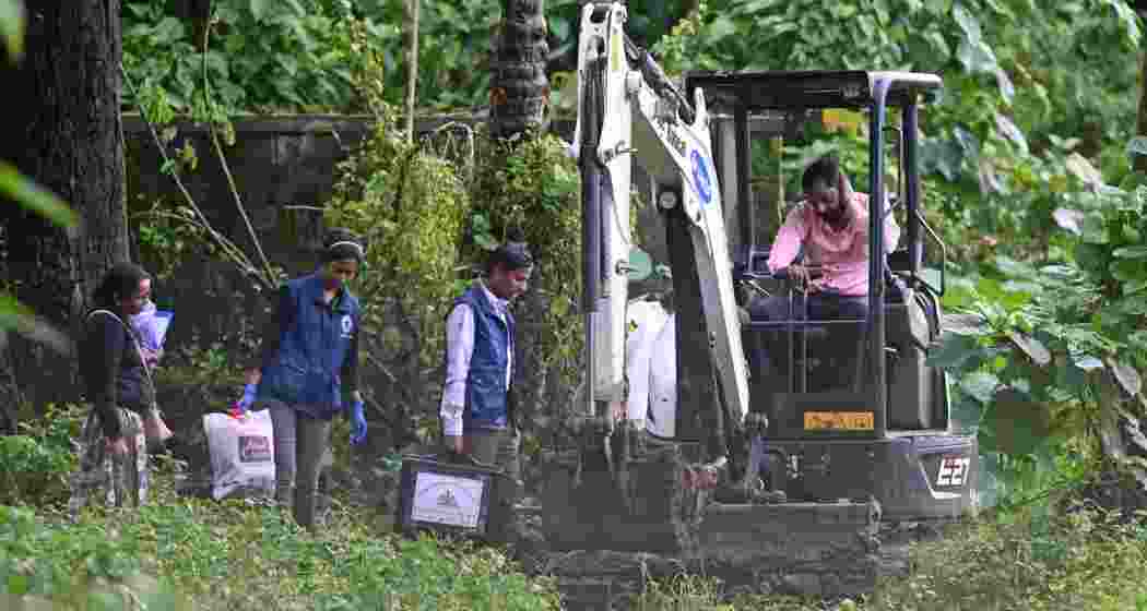 An earth mover was pressed into service to carry out exhumation at the Dharmasthala burial site.