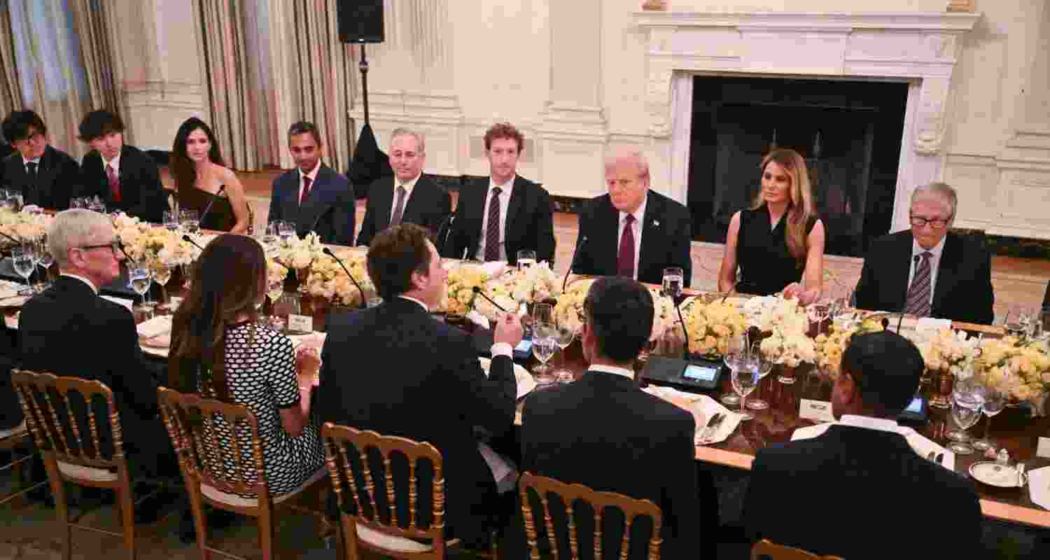 President Donald Trump hosts a dinner with first lady Melania Trump in the State Dinning Room of the White House, Thursday.