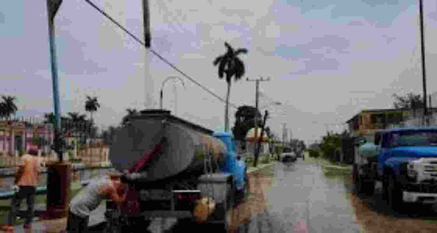 People struggle to carry water from faraway places in Cuba in the absence of water tanker trucks.