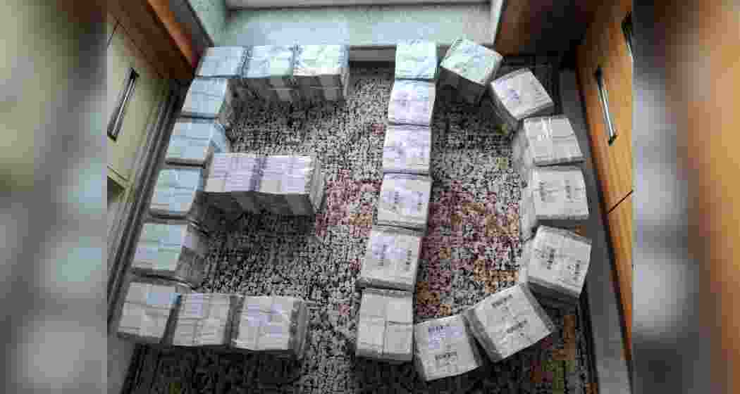 Bundles of cash seized by the Enforcement Directorate, displayed before the media.