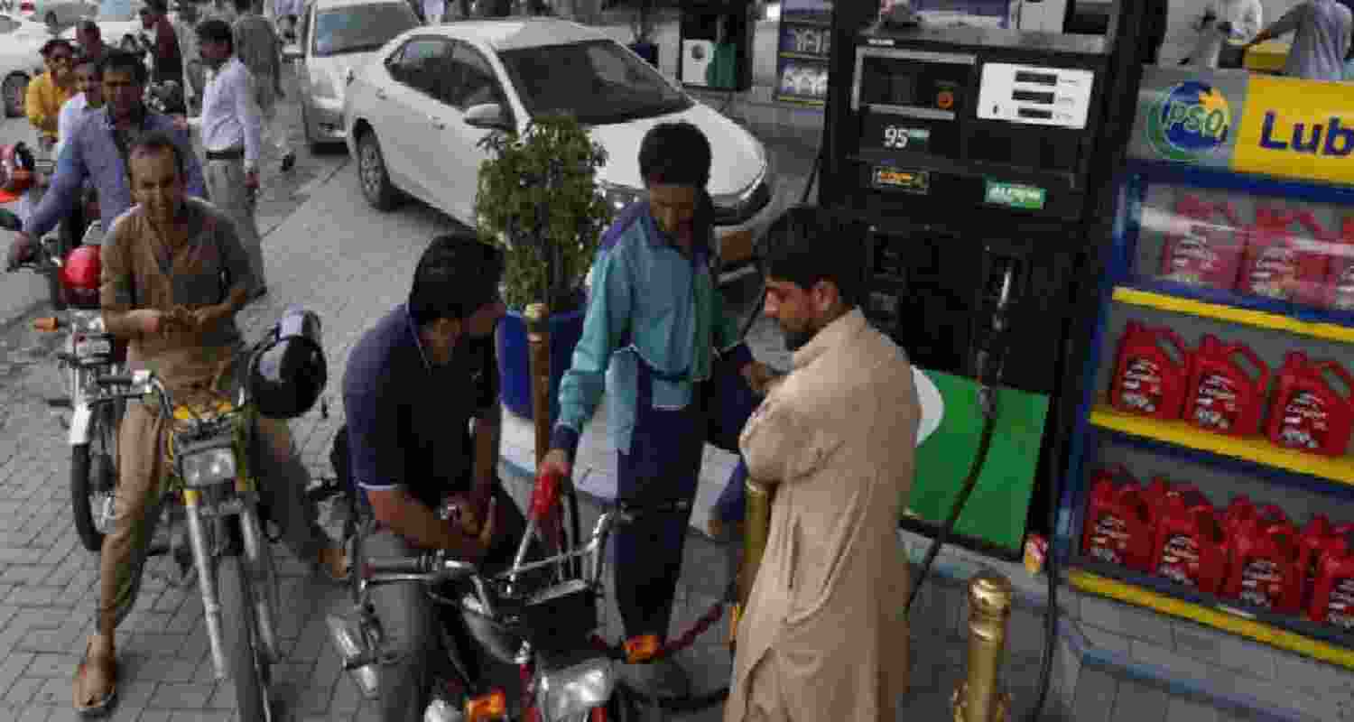 A file photograph of commuters queued up at a petrol pump in Pakistan.