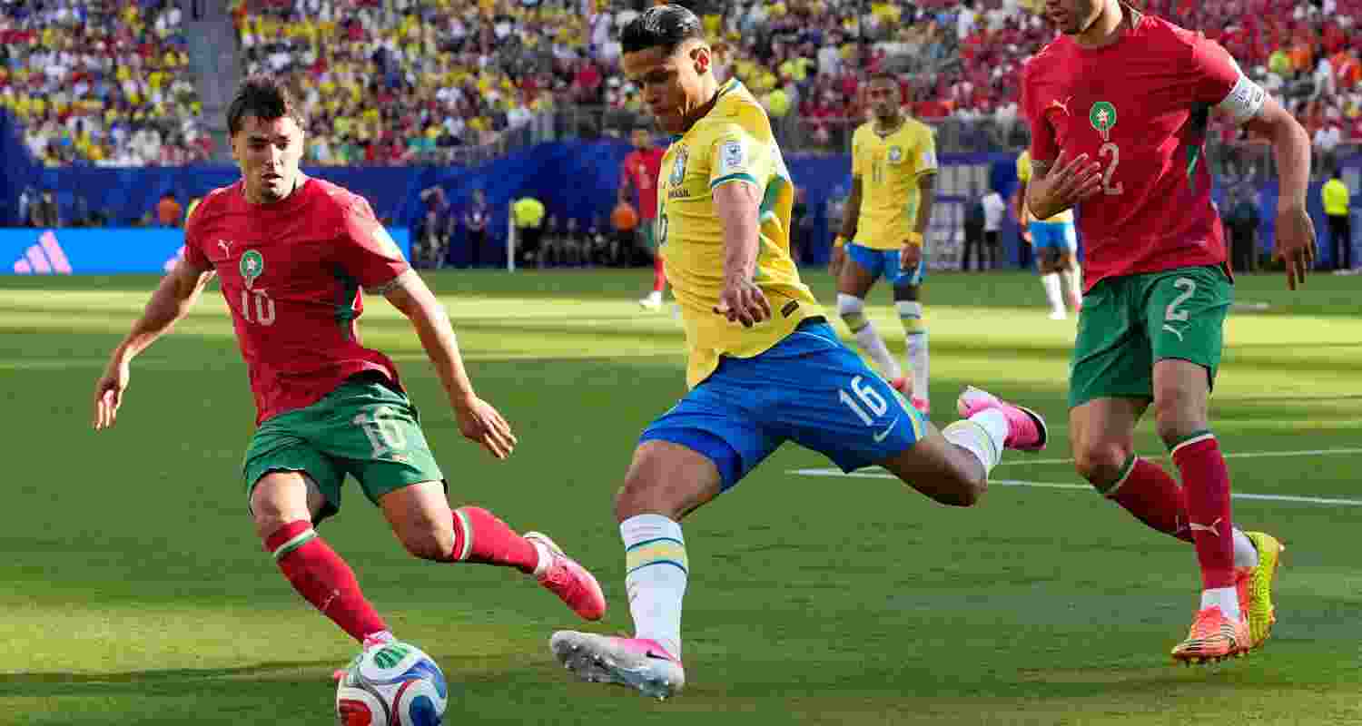 Brazil's Douglas Santos, center, and Morocco's Brahim Diaz battle for the ball during the World Cup Group C soccer match in East Rutherford, N.J., near New York, Saturday, June 13, 2026.