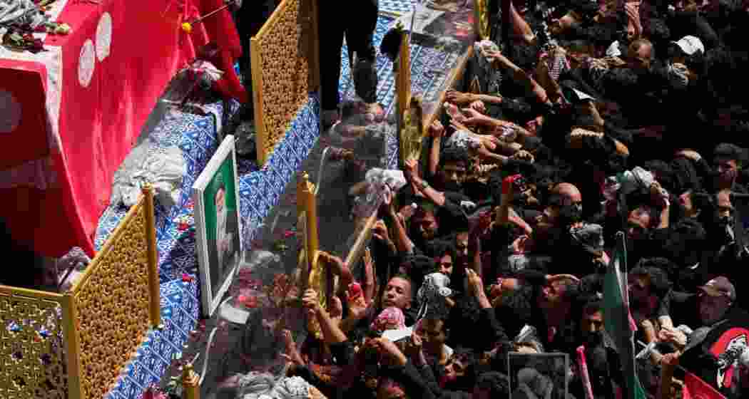 Mourners reach towards a truck carrying the coffin of Iranian Supreme Leader Ayatollah Ali Khamenei during a funeral procession in Najaf, Iraq, on Wednesday.
