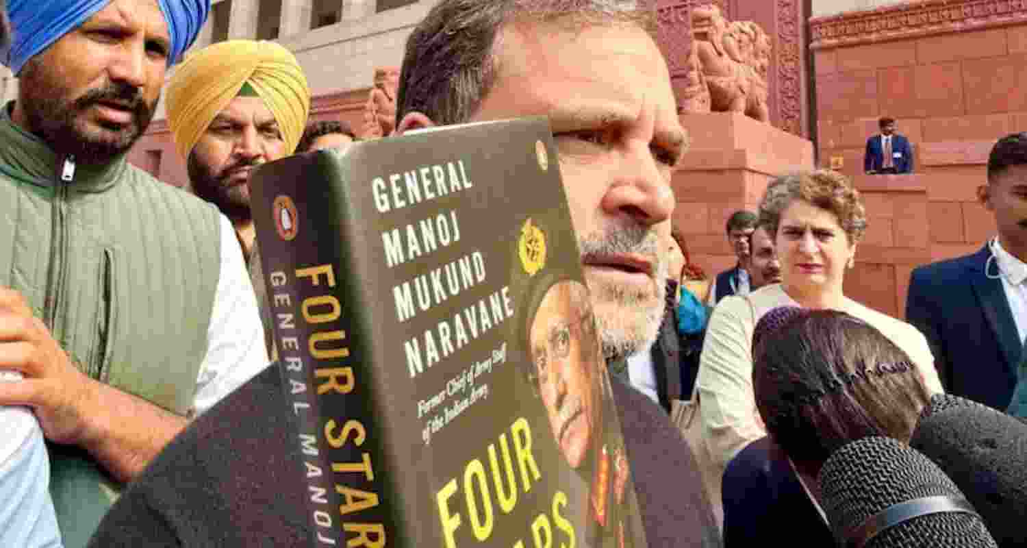 Leader of Opposition in the Lok Sabha Rahul Gandhi brandishing General MM Naravane's memoir in the Parliament complex.
