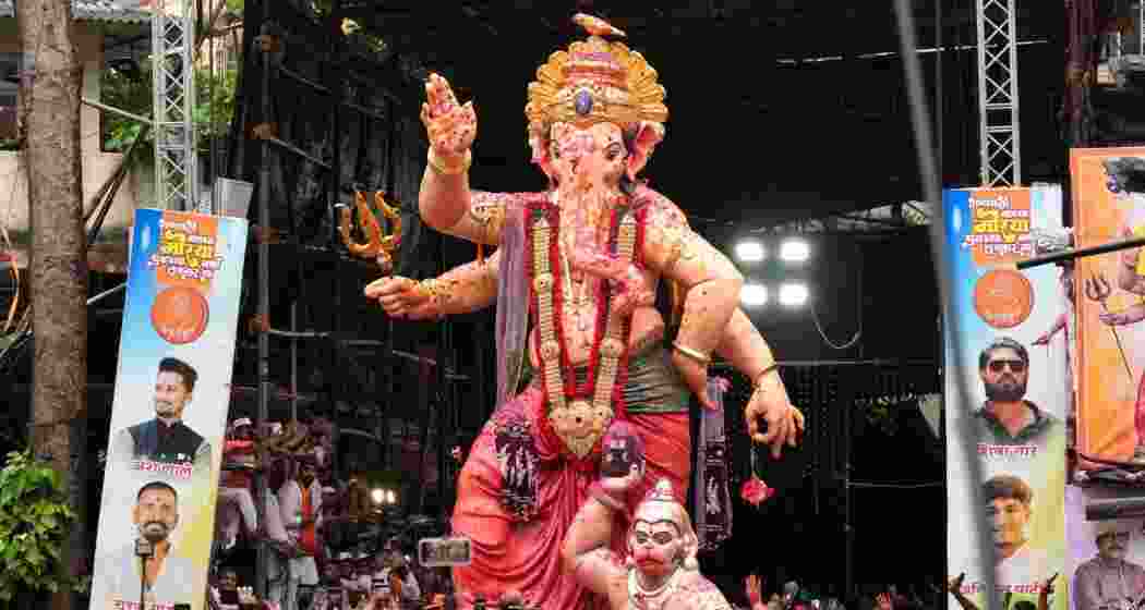 People take part in a procession for immersion of 'Mumbai Cha Raja' idol of Lord Ganesha as part of the Ganesh Chaturthi festival celebrations, in Mumbai, Saturday.