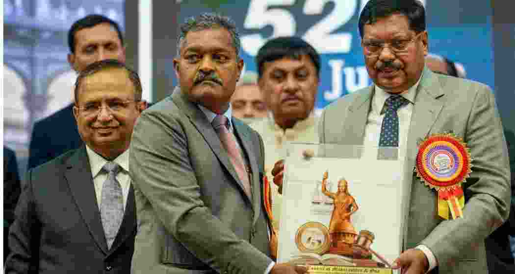 Chief Justice of India Bhushan Ramkrishna Gavai being felicitated by member of Bar Council of Maharashtra and Goa Vitthal Bhaurao Konde-Deshmukh as Chief Justice of Bombay High Court Alok Aradhe looks on during the State Lawyers Conference, in Mumbai, Sunday.