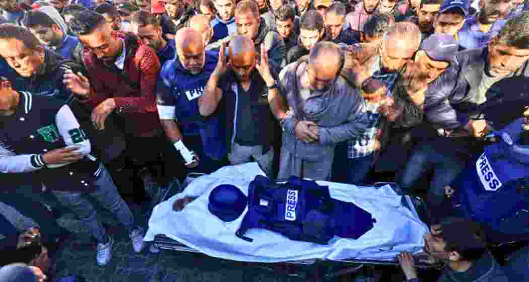 Colleagues and family members mourn during the funeral of Al Jazeera cameraman Samer Abudaqa in Khan Younis, Gaza.