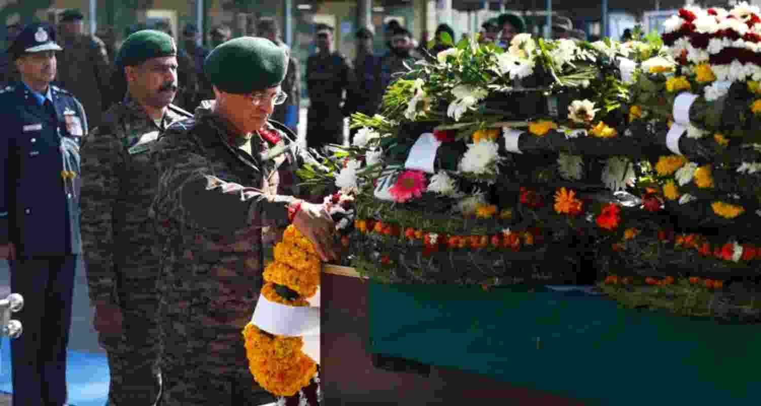 General Officer Commanding of the Jammu-based White Knight Corps Lieutenant General Navin Sachdeva lays a wreath at the mortal remains of the two soldiers who were killed in an IED blast near LoC, in Jammu, Wednesday.