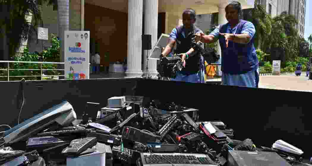 Govt staffers dispose of scraps during a waste-scrapping drive at a government office.