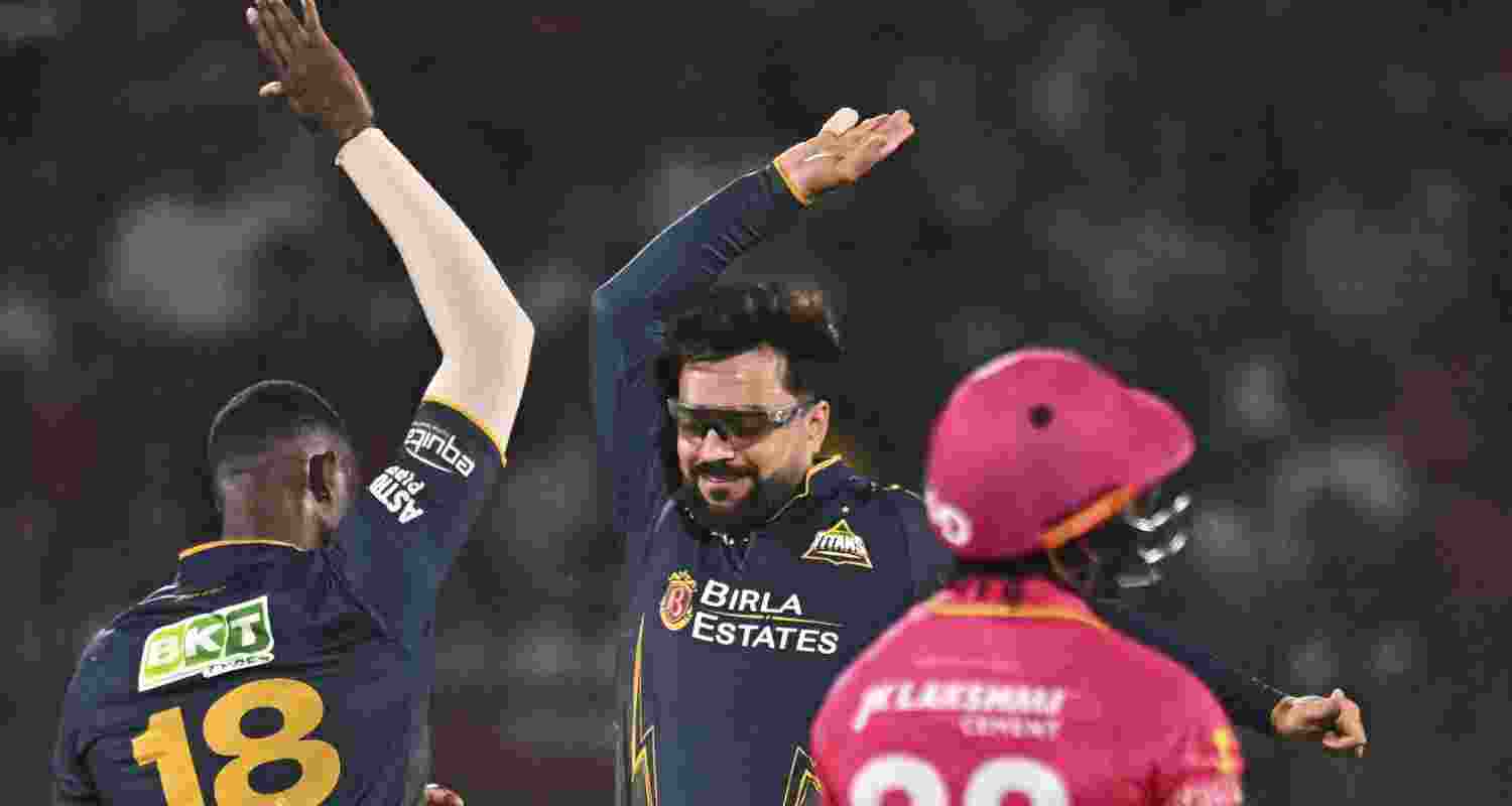 Gujarat Titans' Jason Holder, left, celebrates with Rashid Khan after taking the wicket of Rajasthan Royals' Jofra Archer during an Indian Premier League (IPL) 2026 T20 cricket match between Rajasthan Royals and Gujarat Titans, in Jaipur, Rajasthan, Saturday, May 9, 2026.