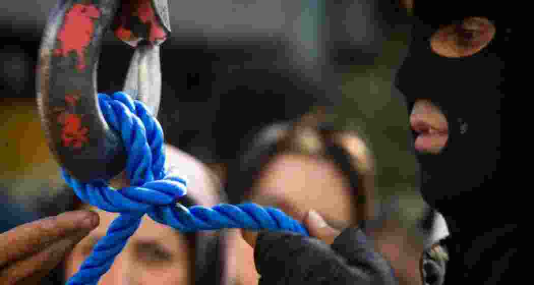 A prison official prepares the execution rope before a scheduled hanging in Iran. 