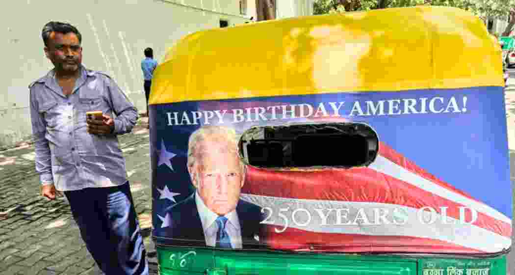 An auto-rickshaw carrying Donald Trump’s portrait and “Happy Birthday America!” slogan moves through New Delhi as part of a US Embassy promotional campaign.