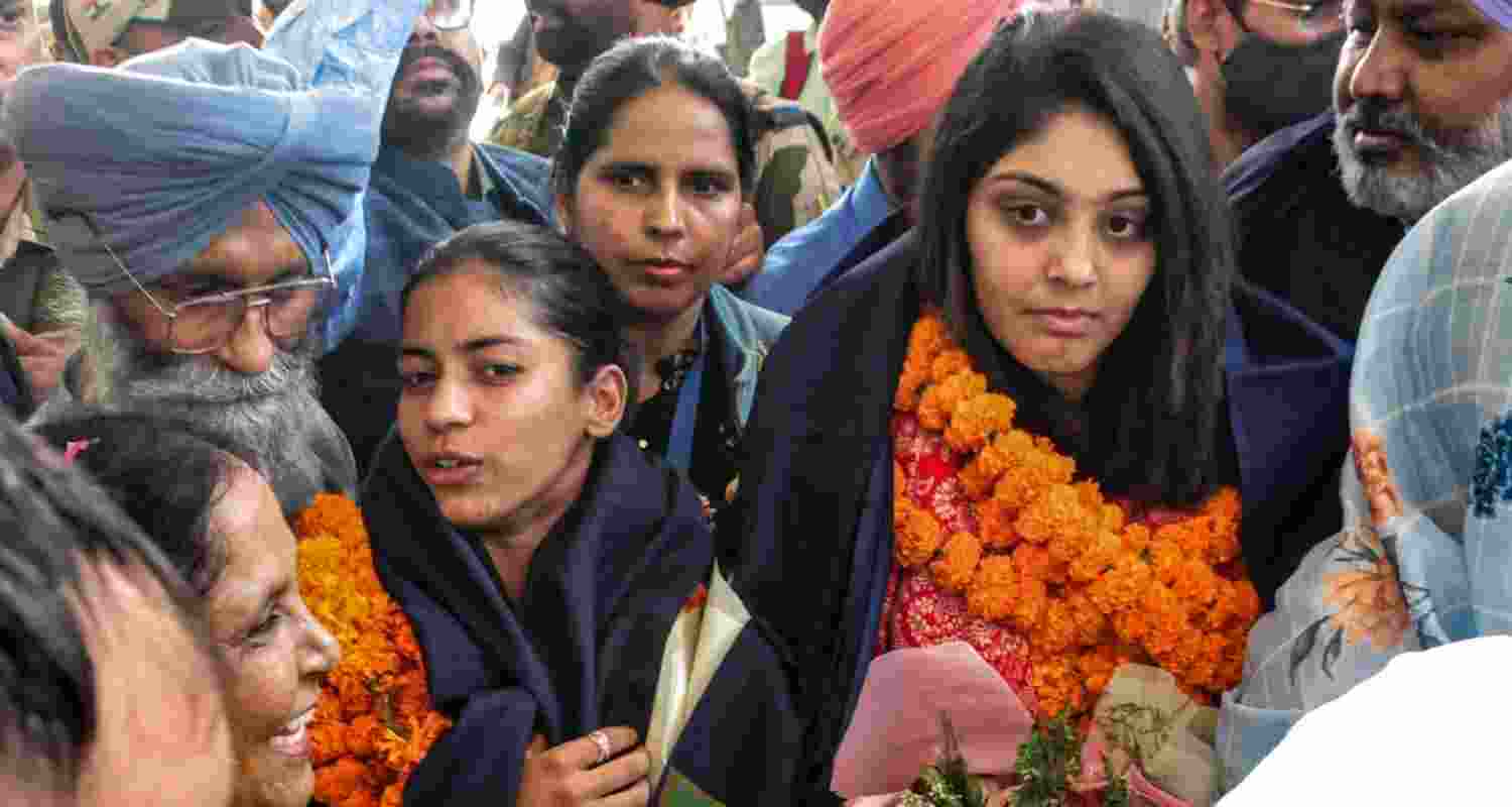 Amanjot Kaur and Harleen Deol, members of the Women's ODI World Cup-winning Indian cricket team, being welcomed by their family members upon their arrival in Mohali on Friday.