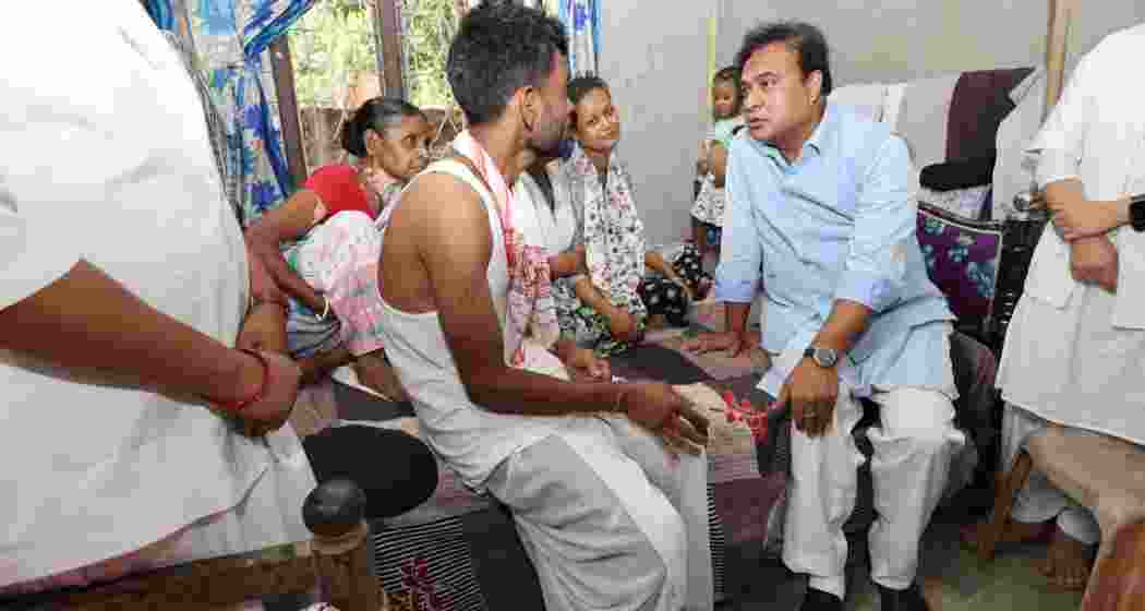 Assam CM Himanta Biswa Sarma consoling the parents of Avinash, who tragically lost his life after falling into a drain during heavy rains and floods in Guwahati on July 4.