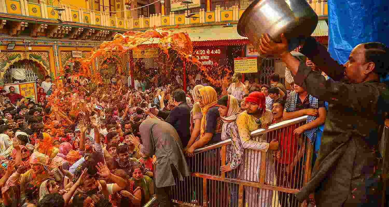 Devotees celebrate with colours during Holi celebration at the Dwarkadhish Temple, in Mathura