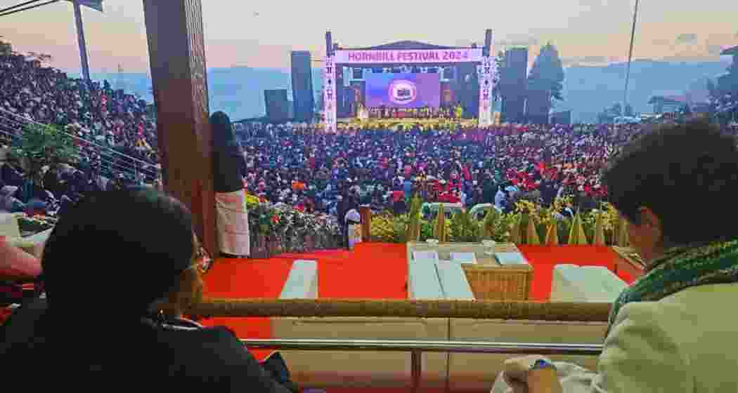 Visitors enjoy the vibrant traditional performances at the 25th Hornbill Festival in Nagaland, which showcases the rich culture, heritage, and unity of the Naga tribes at the Naga Heritage Village.