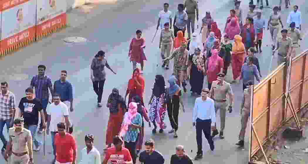 Police officials escort undocumented Bangladeshi nationals during a crackdown in Ahmedabad’s Chandola Lake area on April 26, part of a major operation targeting illegal migration and trafficking networks.