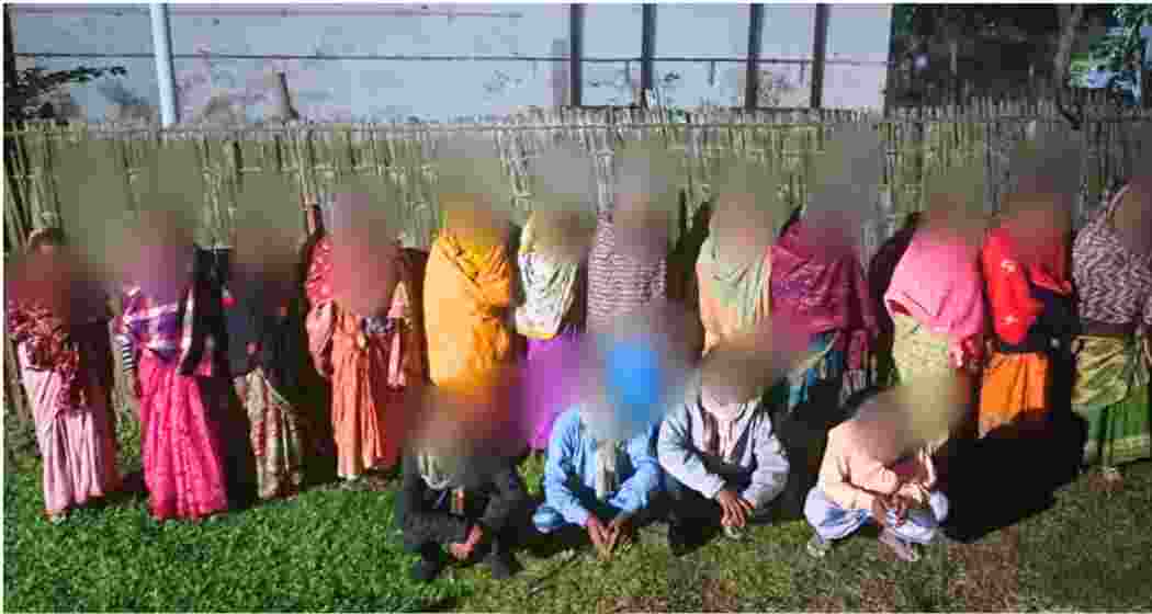 The 18 foreign nationals, apprehended for attempting illegal entry into India, pose for a photograph following their arrest.