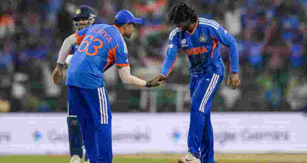 India's Tilak Varma celebrates with captain Suryakumar Yadav after taking wicket of Pakistan's Shadab Khan during an ICC Men's T20 World Cup 2026 cricket match between India and Pakistan, at R Premadasa Stadium, in Colombo, Sri Lanka on Sunday.