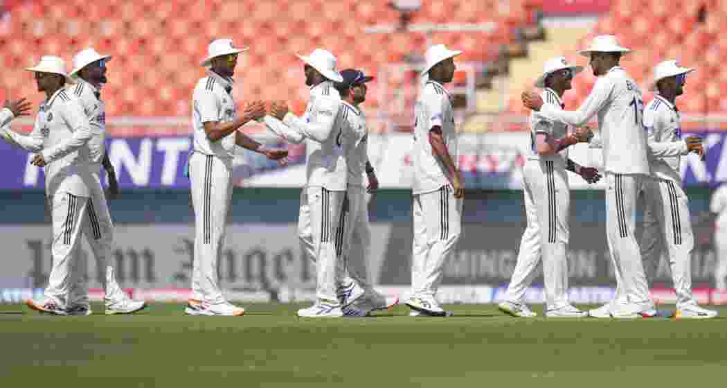  Indian player shake hands after team's win on day three of a Test cricket match between India and Afghanistan, in Mullanpur, on Monday.