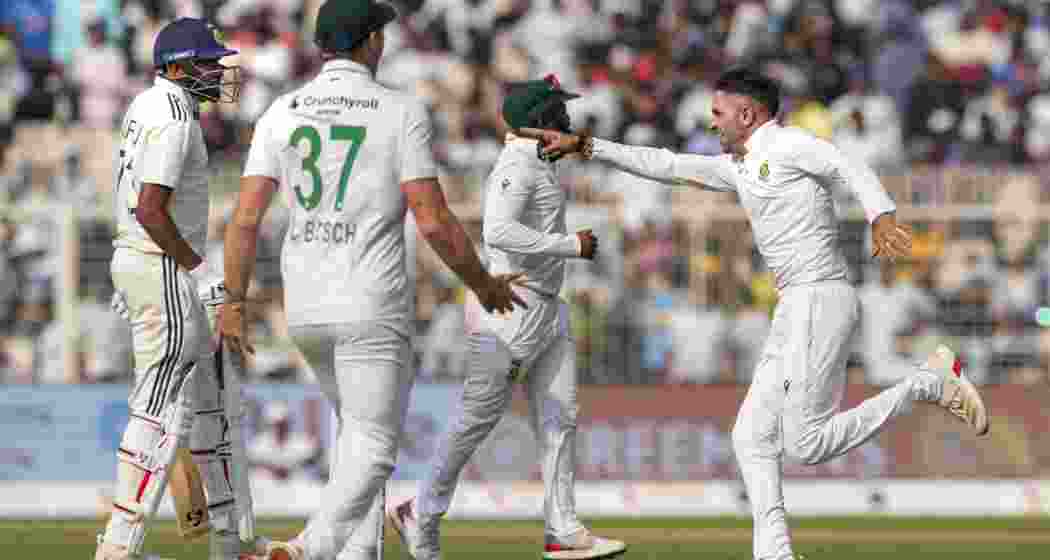 South Africa's Keshav Maharaj with teammates celebrates after the team wins during the third day of the first Test cricket match.