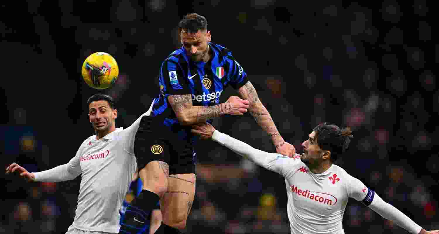 Marko Arnautovic scores a deciding header against Fiorentina while defenders attempt to stop him.