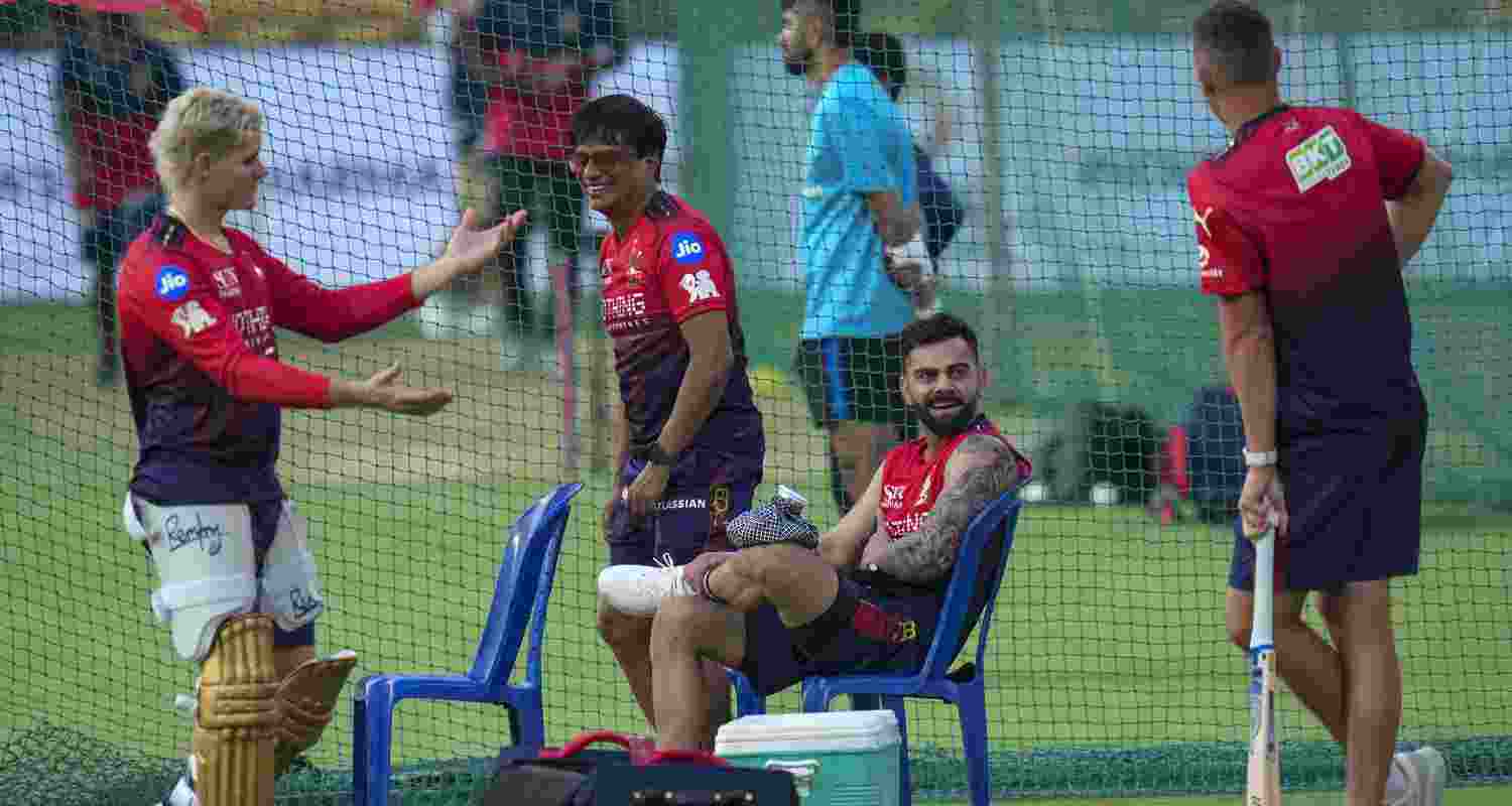 Royal Challengers Bengaluru's Josh Hazlewood, right, Virat Kohli, centre, and others during a practice session on the eve of the Indian Premier League (IPL) 2026 cricket match against Sunrisers Hyderabad, at M Chinnaswamy Stadium in Bengaluru, Karnataka, Friday, March 27, 2026. 