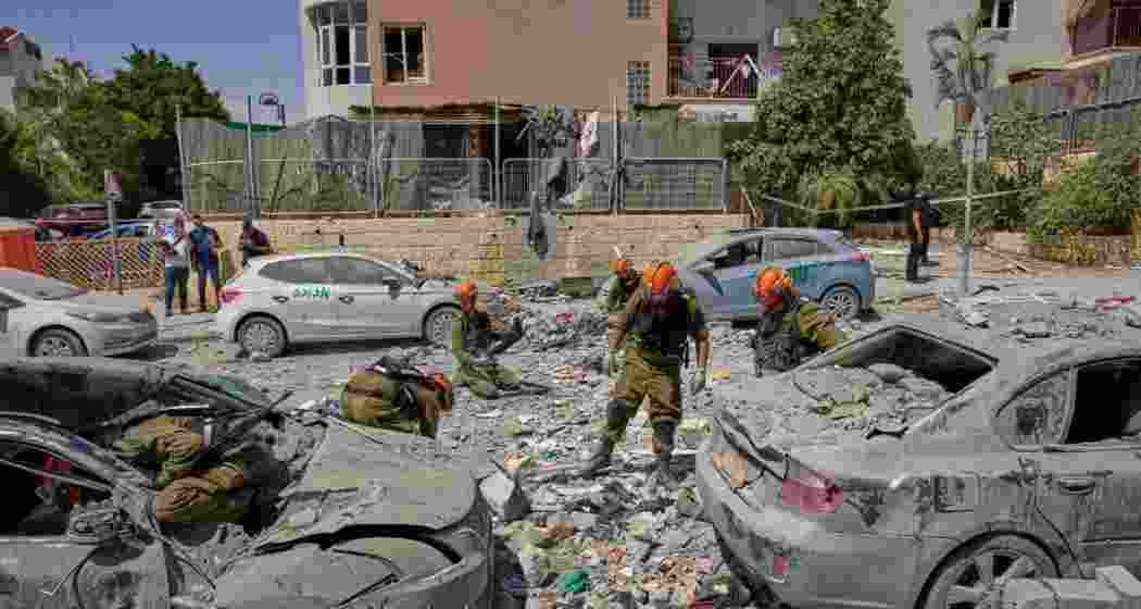 Israeli soldiers work amid the rubble of residential buildings destroyed by an Iranian missile strike that killed several people, in Beersheba, Israel, on Tuesday. Israeli soldiers work amid the rubble of residential buildings destroyed by an Iranian missile strike that killed several people, in Beersheba, Israel, on Tuesday.