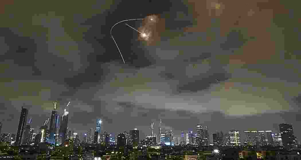 Smoke rises over Holon after Iranian missiles struck central Israel.