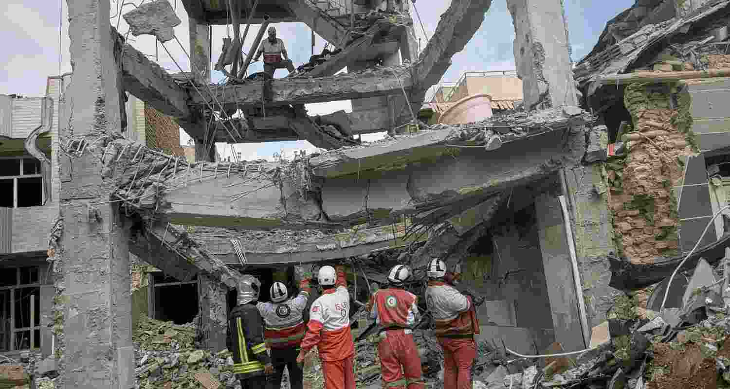 First responders inspect the remains of a residential building hit in an overnight strike during the U.S.-Israeli military campaign in Tabriz, East Azerbaijan Province, northwestern Iran, Tuesday. 