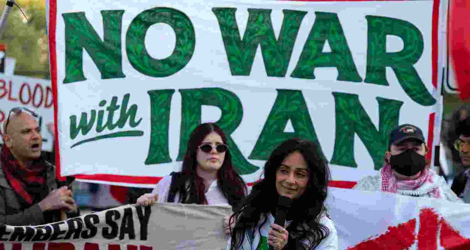 Activists protest at Lafayette Park near the White House in Washington, Tuesday evening, April 7, 2026.
