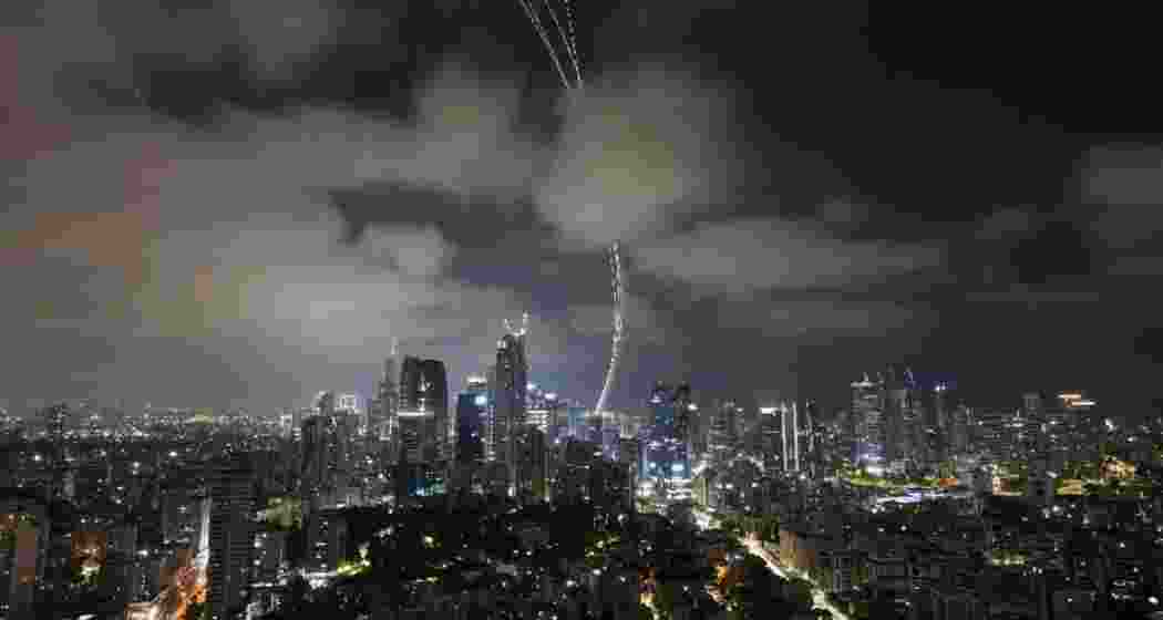 Israel's air defense system fire to intercepts missiles launched from Iran, over Tel Aviv. (Photo: PTI)