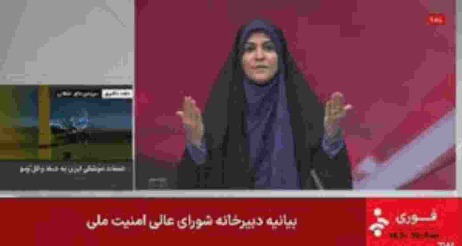 Israel State TV anchor Sahar Imami runs for cover as an Israeli missile strikes during a bulletin.