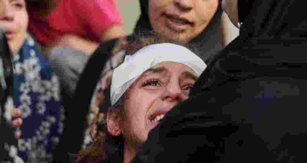 A girl mourns at Gaza City's Baptist Hospital after an Israeli airstrike killed her relatives. 