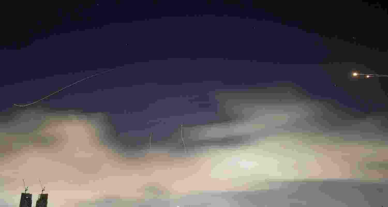 Israeli air defense system fires to intercept missiles during an Iranian attack over Tel Aviv, Israel, early Sunday, March 15, 2026.