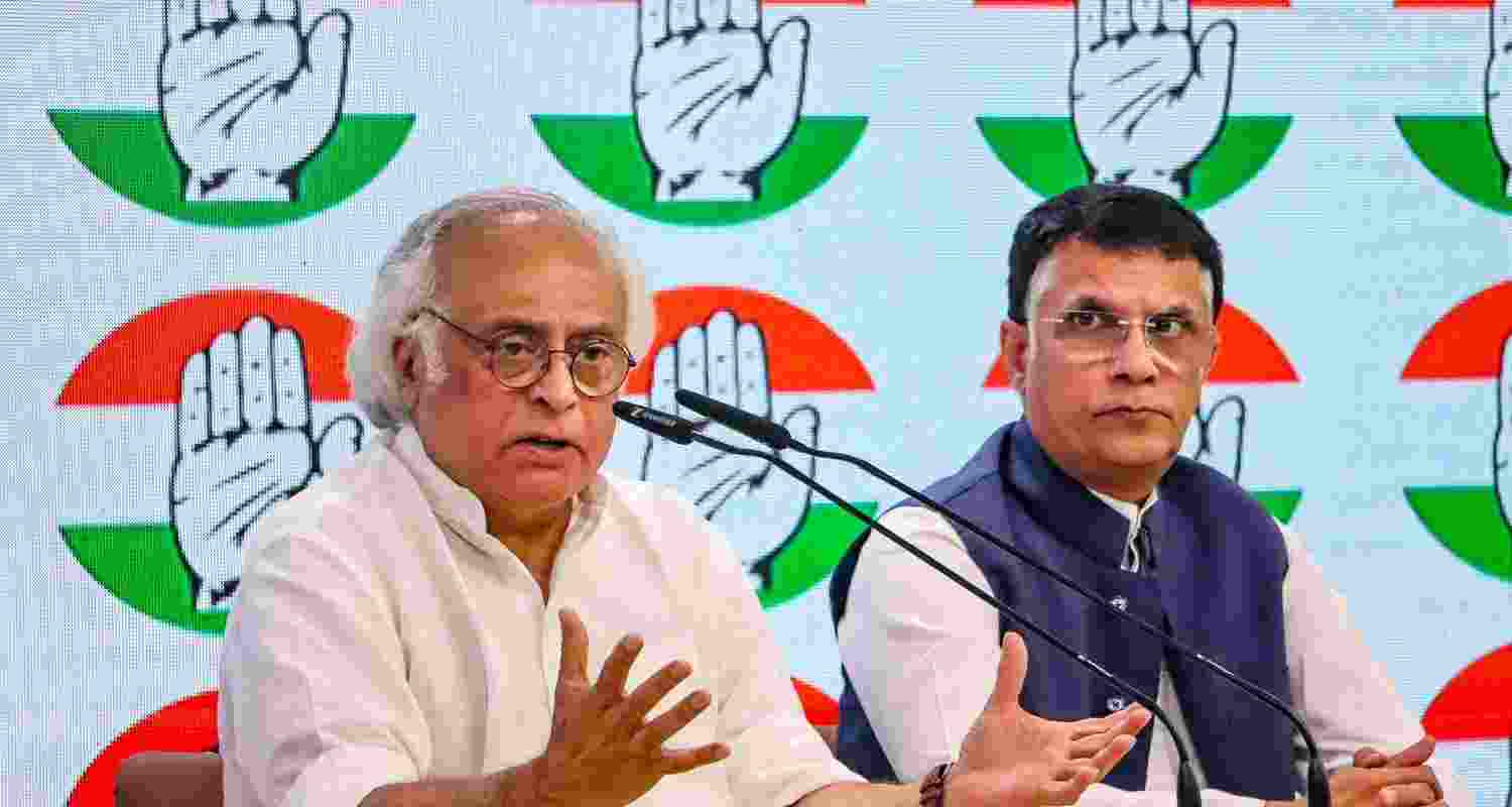Congress leaders Jairam Ramesh and Pawan Khera address a press conference at AICC headquarters, in New Delhi, Tuesday.
