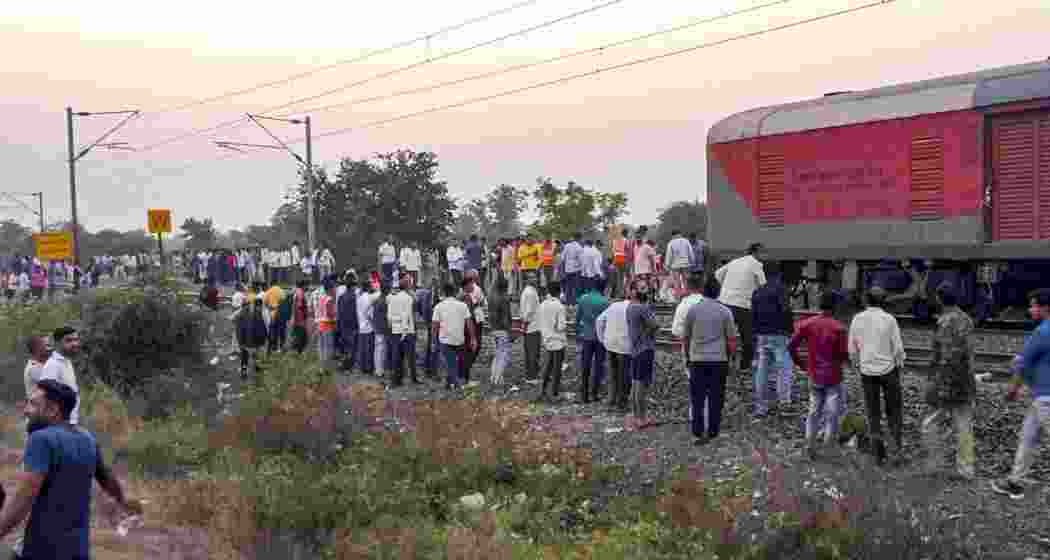 People gather after the train mishap, in Jalgaon district of Maharashtra on Wednesday, Jan. 22, 2025. At least 13 passengers were killed on Wednesday evening when they jumped from their train in panic due to a `fire incident', only to be run over by another train on the adjacent tracks.