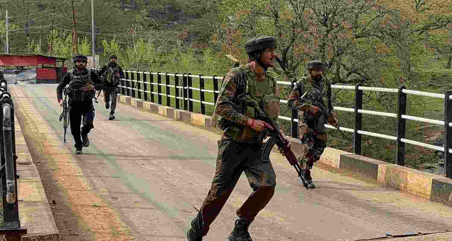Security personnel rush to the spot after terrorists attacked a group of tourists at Pahalgam, in Anantnag district, Jammu & Kashmir, Tuesday. 